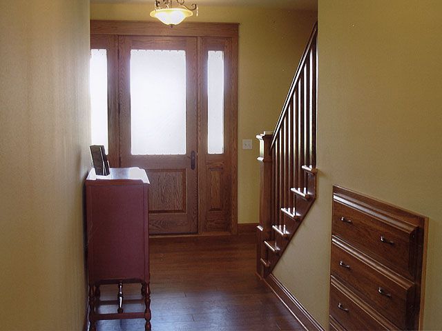 Interior entryway and staircase with finished woodwork