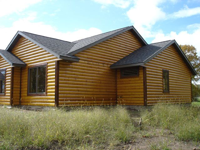Log home exterior with natural wood finish